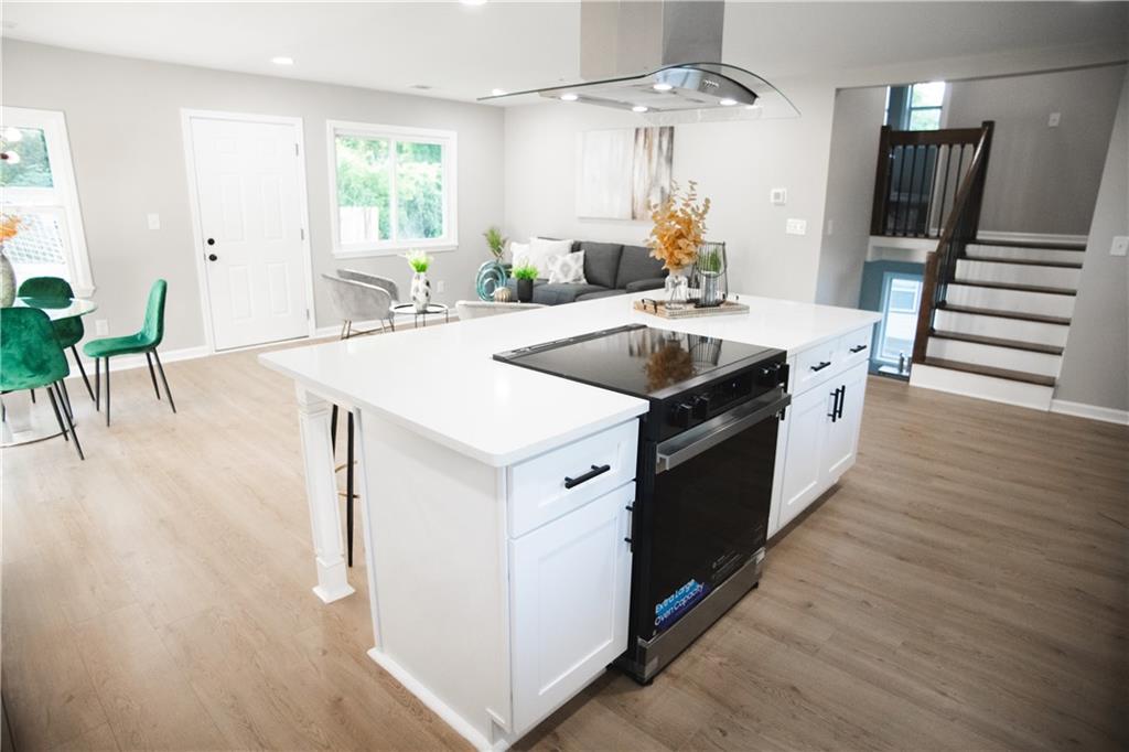 3561 Misty Valley Road Decatur, GA 30032 - Photo 13 of 56 a kitchen with a stove and a wooden floor
