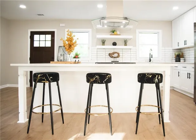 a view of a hallway with furniture and wooden floor