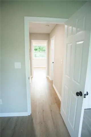 a view of a hallway with wooden floor