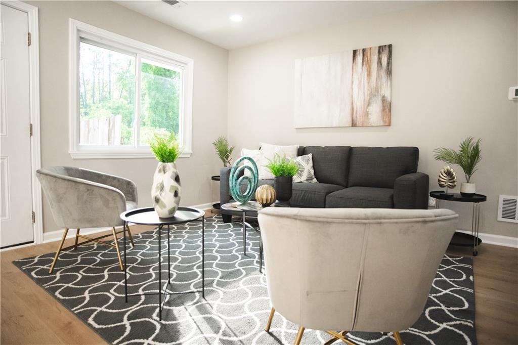 3561 Misty Valley Road Decatur, GA 30032 - Photo 34 of 56 a living room with a couch and a potted plant