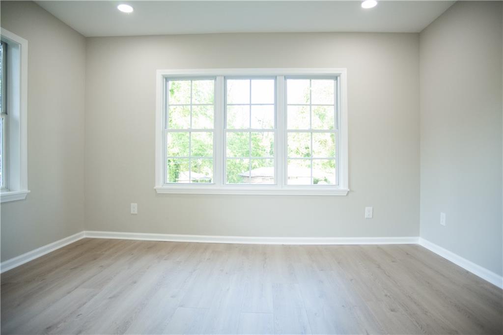 3561 Misty Valley Road Decatur, GA 30032 - Photo 39 of 56 an empty room with wooden floor and windows