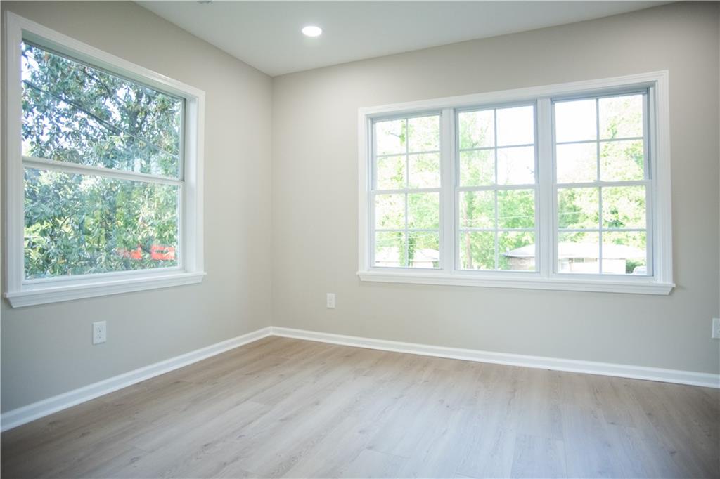 3561 Misty Valley Road Decatur, GA 30032 - Photo 40 of 56 an empty room with wooden floor and windows