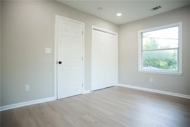 a view of entryway and hall with wooden floor