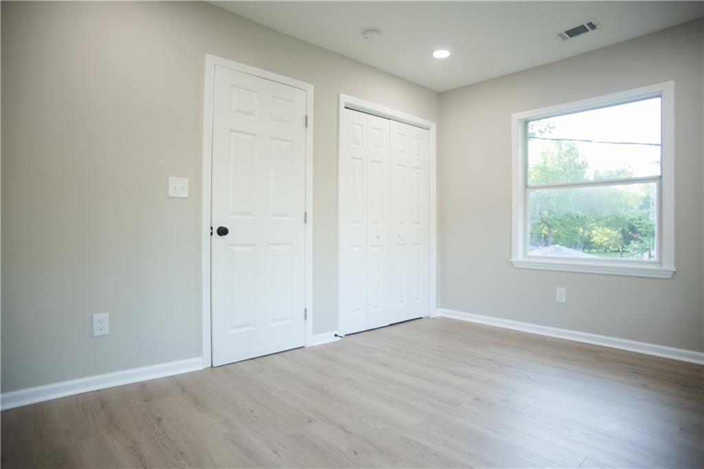 3561 Misty Valley Road Decatur, GA 30032 - Photo 41 of 56 an empty room with wooden floor and windows