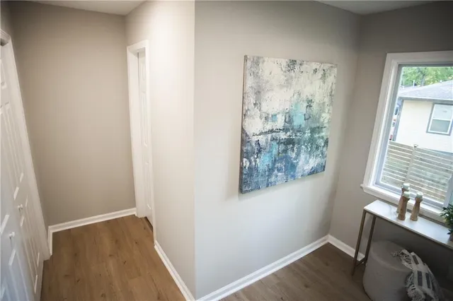 a large white bed in a bedroom next to a window