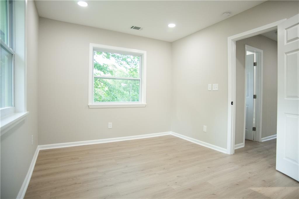 3561 Misty Valley Road Decatur, GA 30032 - Photo 5 of 56 a view of an empty room with wooden floor and a window