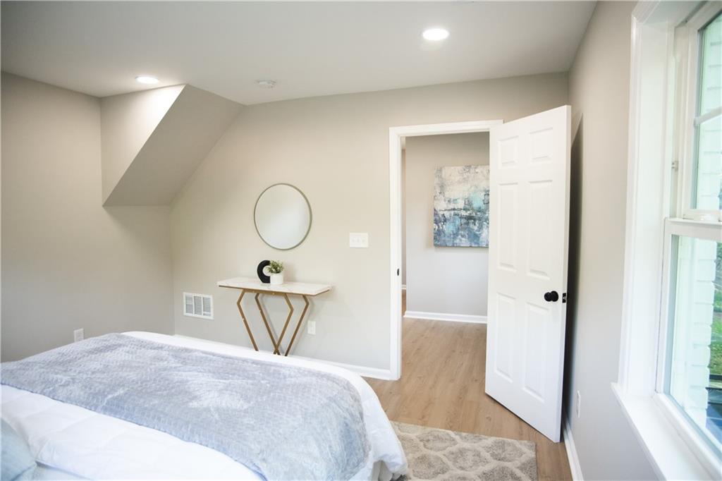 3561 Misty Valley Road Decatur, GA 30032 - Photo 52 of 56 a bedroom with a bed and a mirror