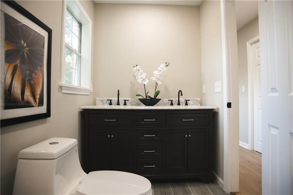 3561 Misty Valley Road Decatur, GA 30032 - Photo 53 of 56 a bathroom with a toilet a sink and mirror
