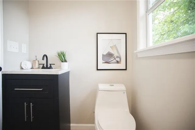 a bathroom with a toilet sink and mirror