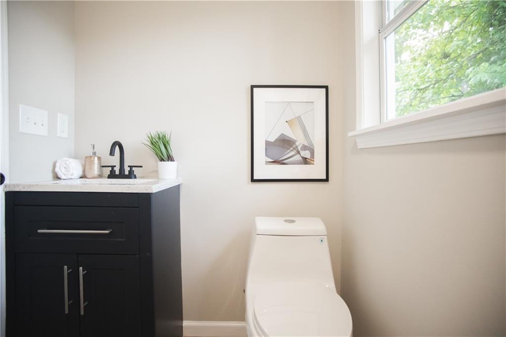 3561 Misty Valley Road Decatur, GA 30032 - Photo 10 of 56 a bathroom with a toilet sink and mirror