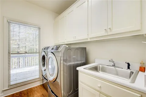a bathroom with a granite countertop sink a mirror and a shower