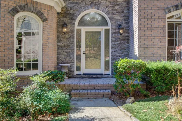 a front view of a house with a garden