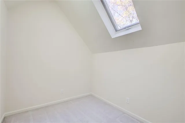 a view of a blue house with a large space