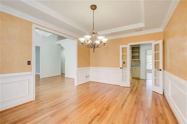 a view of a livingroom with wooden floor and a large window