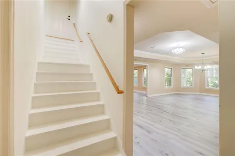 a view of a tennis ground with large trees