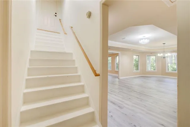 a view of a tennis ground with large trees
