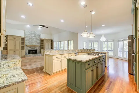a kitchen with granite countertop a stove oven and a fireplace