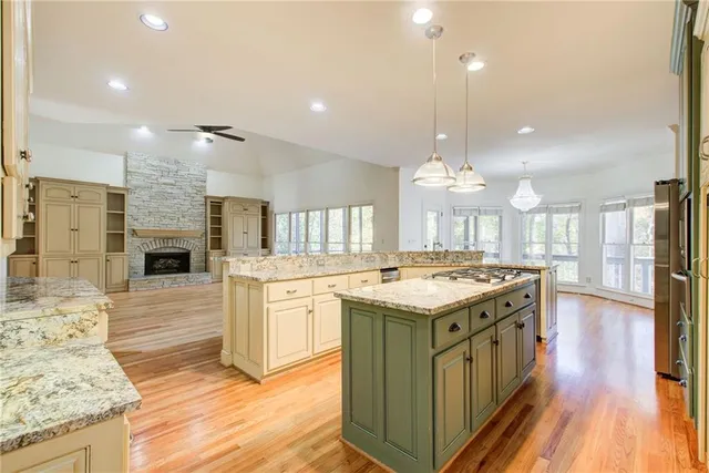 a kitchen with granite countertop a stove oven and a fireplace