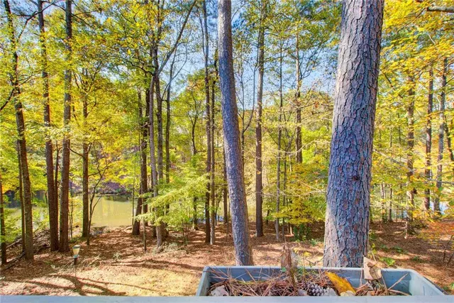 a view of a hallway with wooden floor and closet area