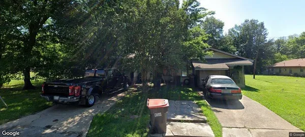 a backyard of a house with fountain and outdoor seating