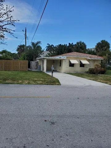 a view of backyard of house and green space