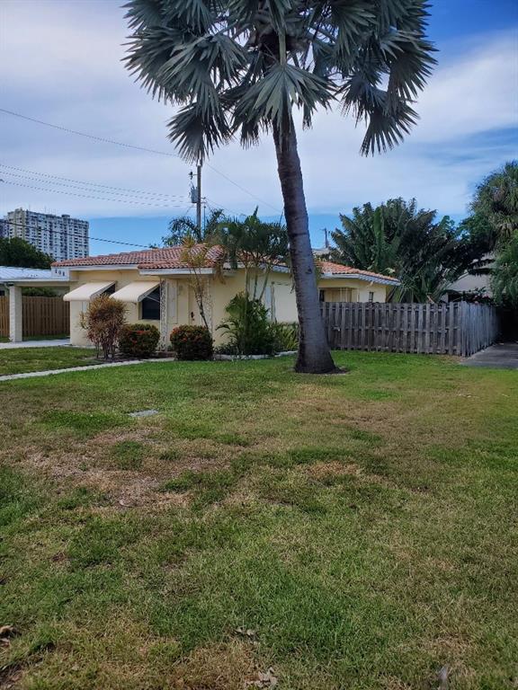 608 South Riverside Drive Pompano Beach, FL 33062 - Photo 3 of 7 a view of a house with a garden and yard