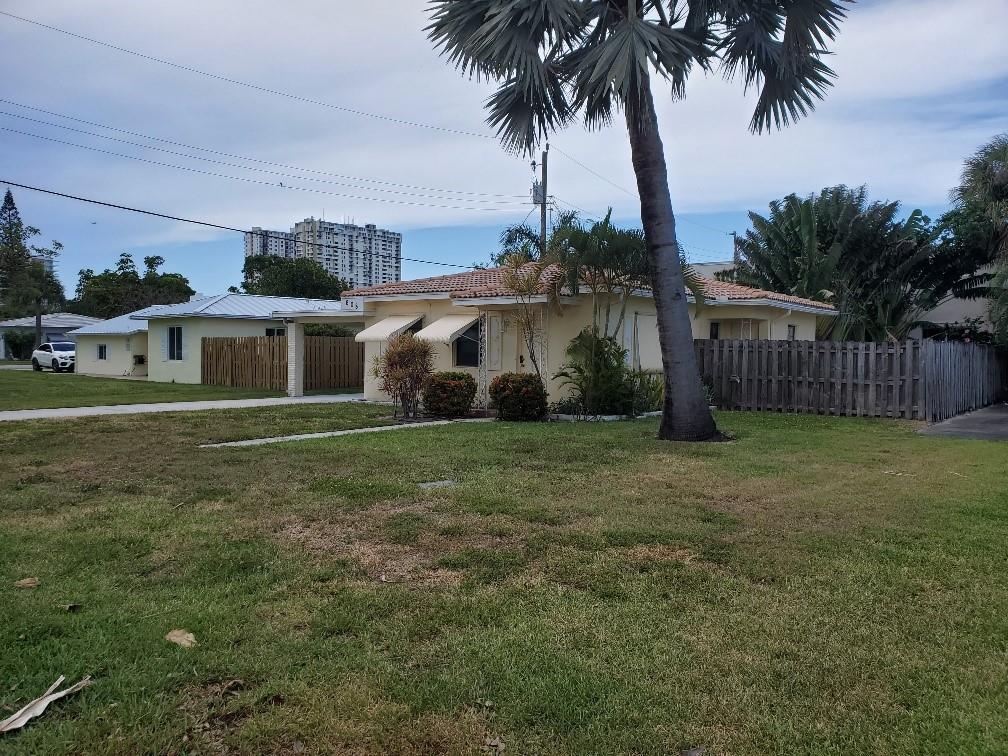 608 South Riverside Drive Pompano Beach, FL 33062 - Photo 6 of 7 a front view of a house with garden