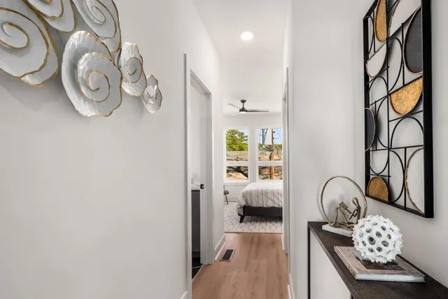 a bedroom with a bed and wooden floor