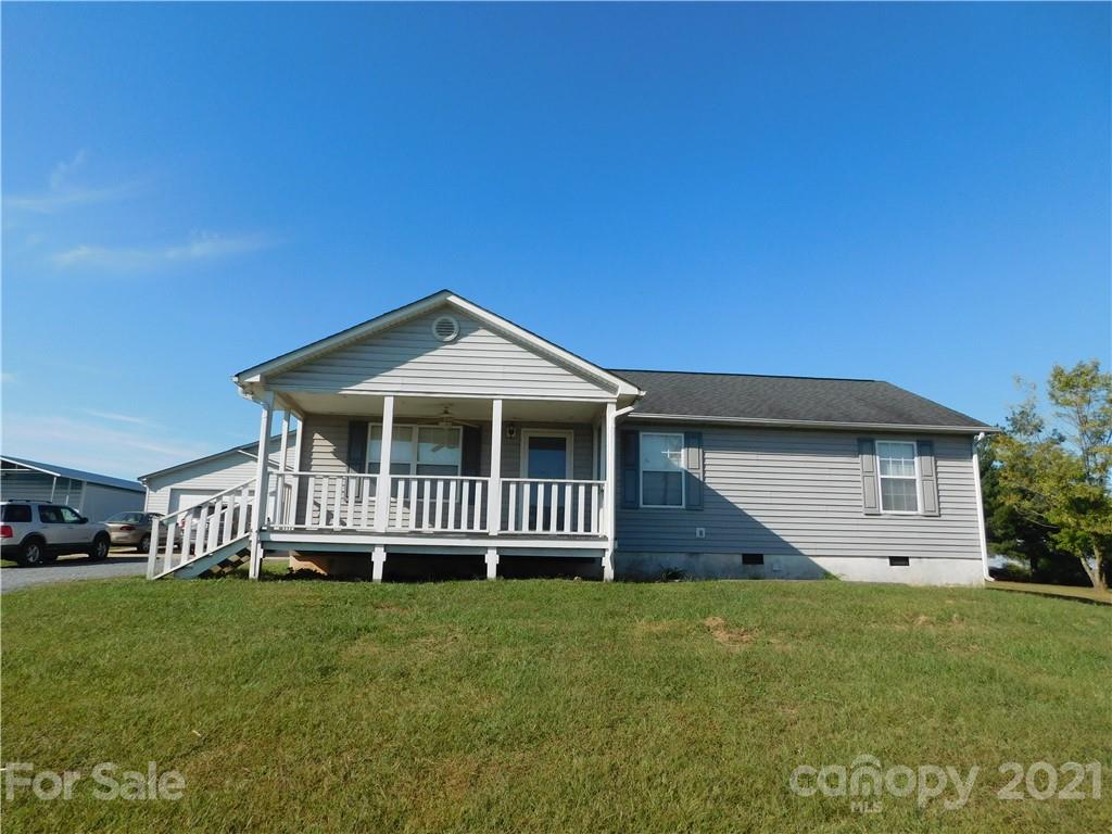 5510 Wolf Pond Road Monroe, NC 28112 - Photo 1 of 16 a front view of a house with a garden