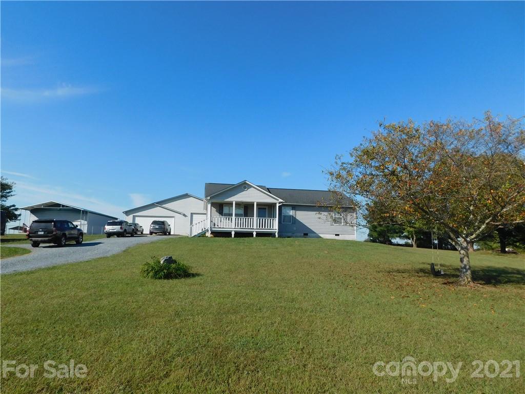 5510 Wolf Pond Road Monroe, NC 28112 - Photo 2 of 16 a front view of a house with a garden and yard
