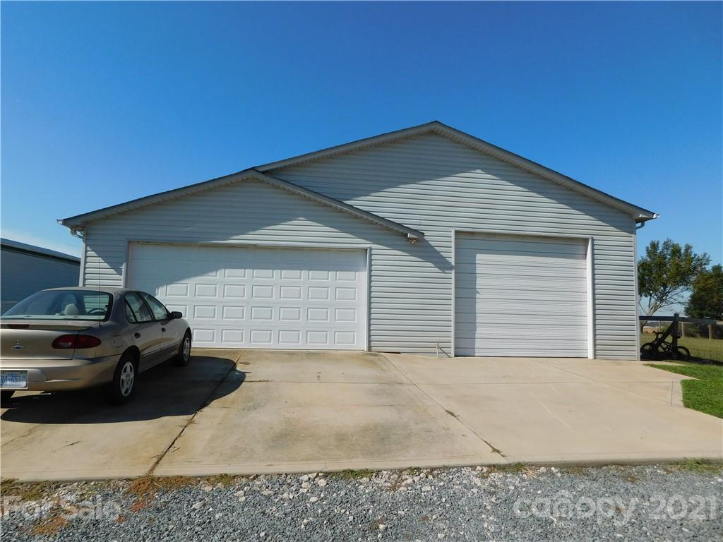 5510 Wolf Pond Road Monroe, NC 28112 - Photo 13 of 16 a view of garage with parked car
