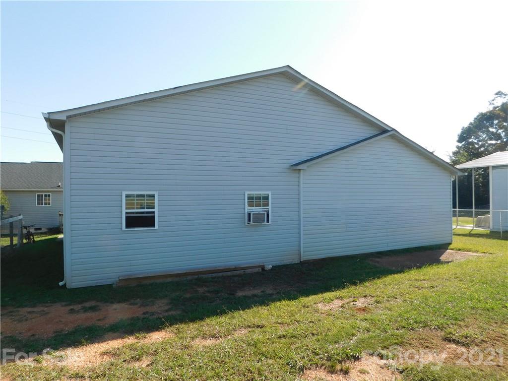 5510 Wolf Pond Road Monroe, NC 28112 - Photo 15 of 16 a view of a backyard of the house