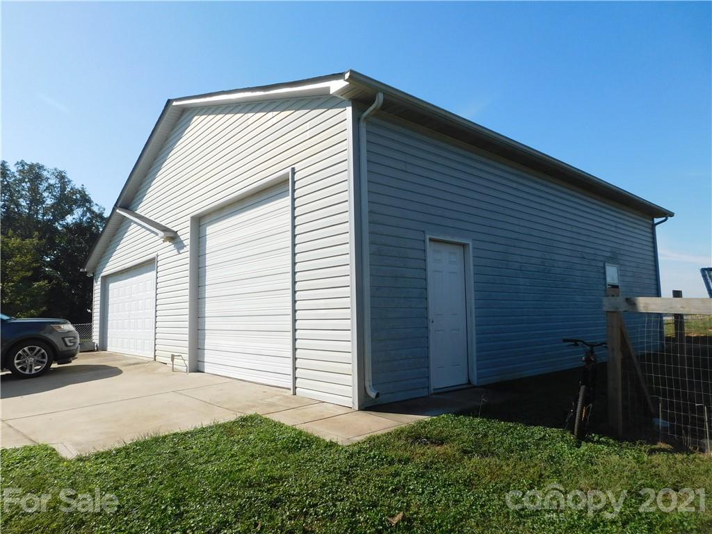 5510 Wolf Pond Road Monroe, NC 28112 - Photo 16 of 16 a front view of a house with a garden