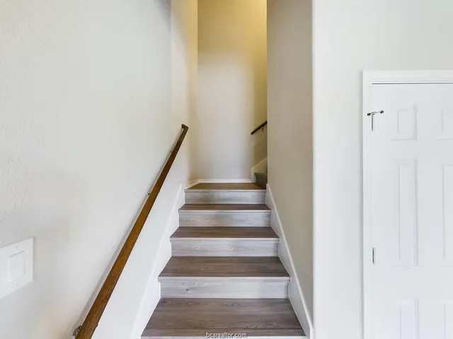 a view of staircase with white walls