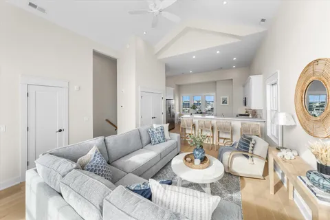 a living room with stainless steel appliances kitchen island granite countertop furniture and a large window