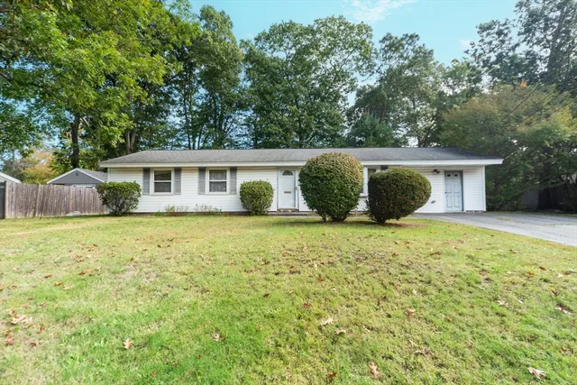 a view of a house with a backyard