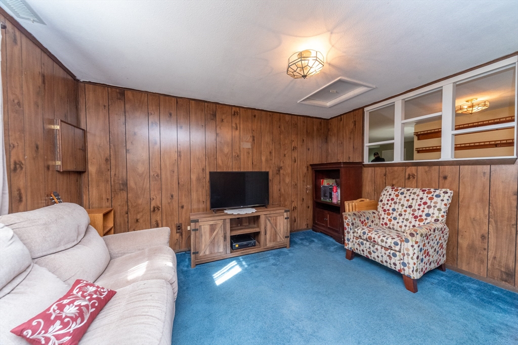 221 Sinclair Road Brockton, MA 02302 - Photo 13 of 26 a living room with furniture and a flat screen tv