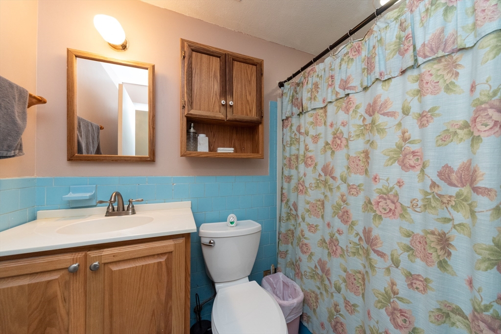 221 Sinclair Road Brockton, MA 02302 - Photo 16 of 26 a bathroom with a sink a toilet and a mirror