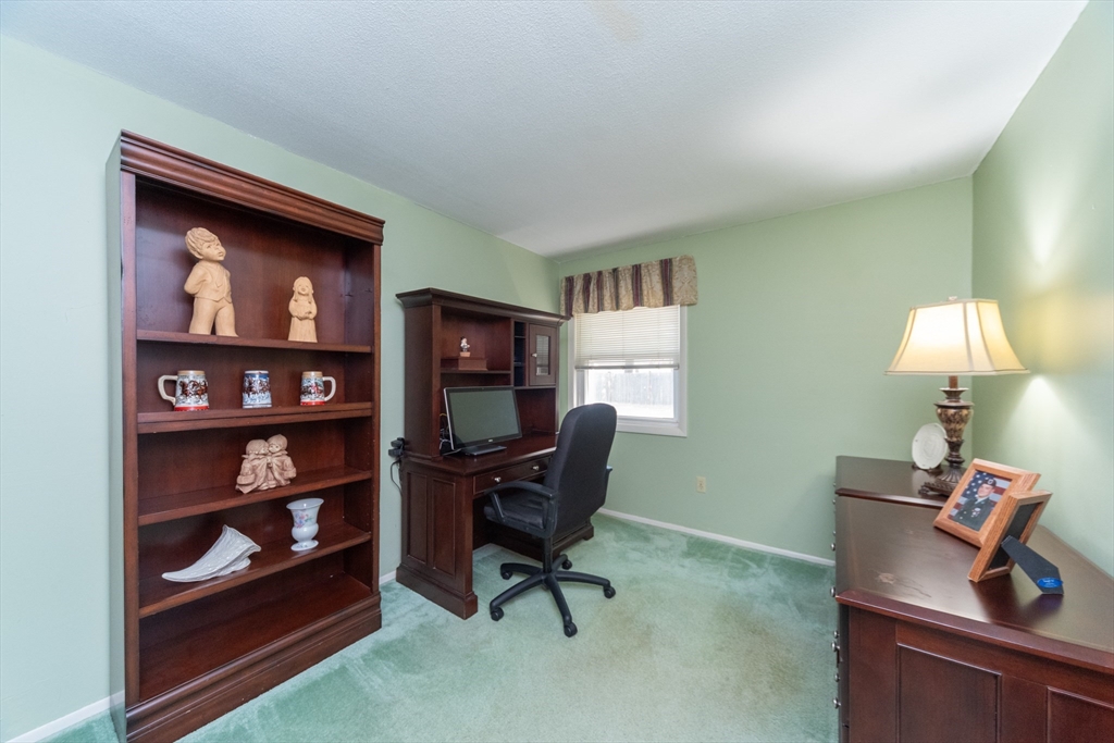 221 Sinclair Road Brockton, MA 02302 - Photo 17 of 26 a view of a workspace with a bookshelf