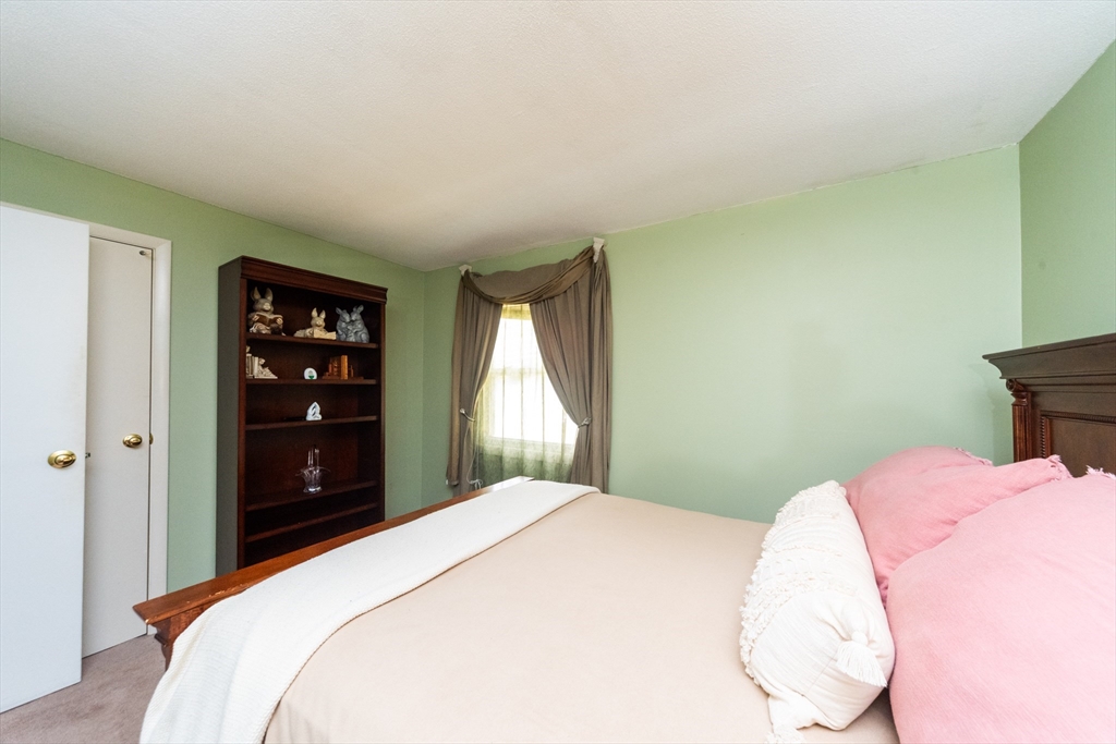 221 Sinclair Road Brockton, MA 02302 - Photo 21 of 26 a bedroom with a bed and a flat screen tv