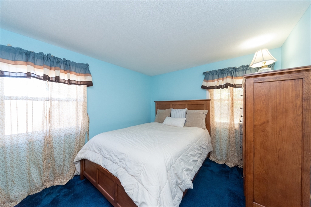 221 Sinclair Road Brockton, MA 02302 - Photo 22 of 26 a bedroom with a bed and wooden floor