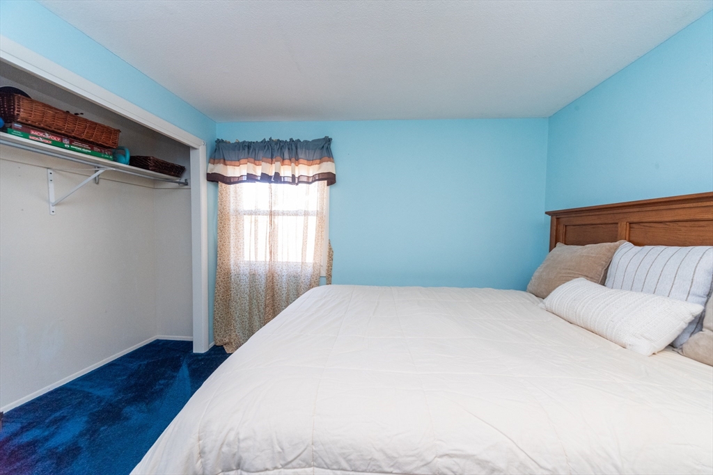 221 Sinclair Road Brockton, MA 02302 - Photo 23 of 26 a bedroom with a bed and wooden floor