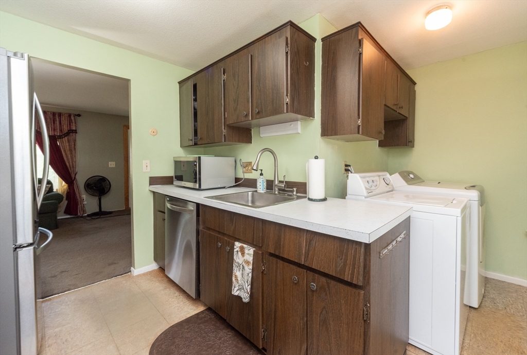 221 Sinclair Road Brockton, MA 02302 - Photo 8 of 26 a kitchen that has a sink and a stove in it