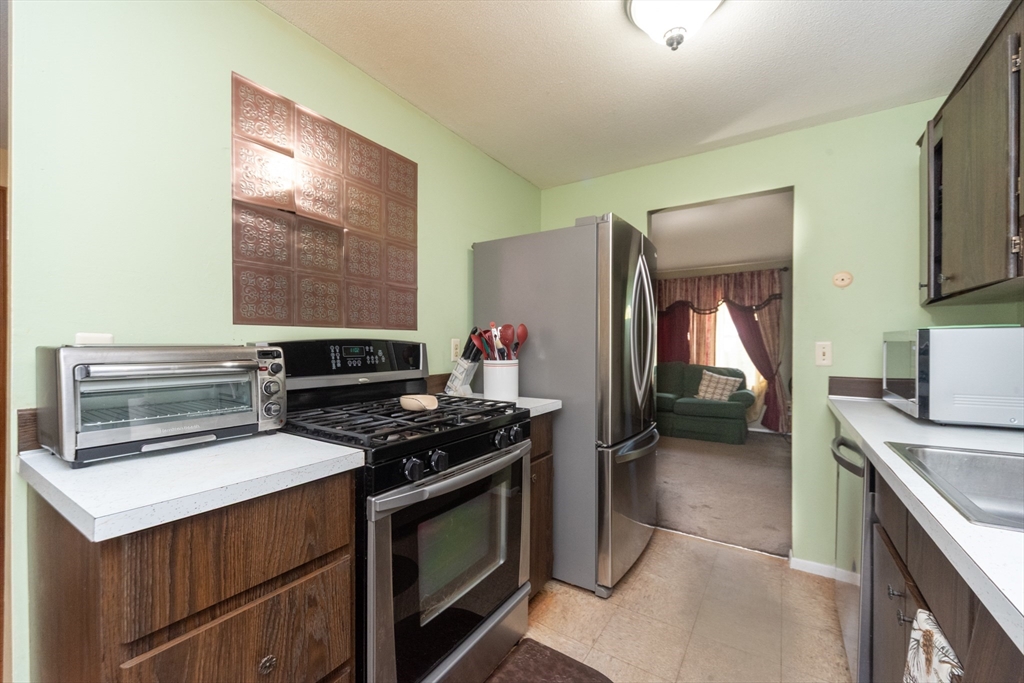 221 Sinclair Road Brockton, MA 02302 - Photo 9 of 26 a kitchen with a stove and a microwave