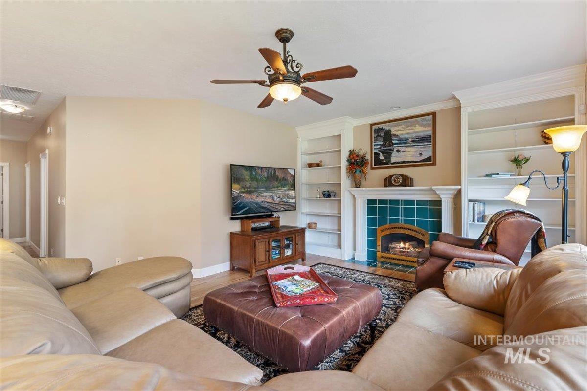 5184 North Greyloch Way Boise, ID 83704 - Photo 10 of 32 Living area featuring a fireplace with teal tile surround and white mantelpiece