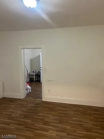 a view of a room with wooden floor and chair