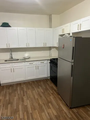 a kitchen with a sink stainless steel appliances and cabinets