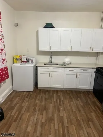 a kitchen with granite countertop a sink and a stove
