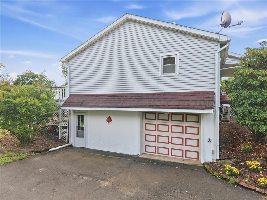 74 Swiss View Road Lehighton, PA 18235 - Photo 52 of 59 A drive-under garage provides convenient lower-level access beneath the classic vinyl-sided exterior.