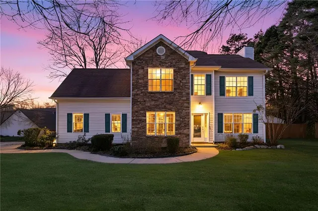 a front view of a house with a garden